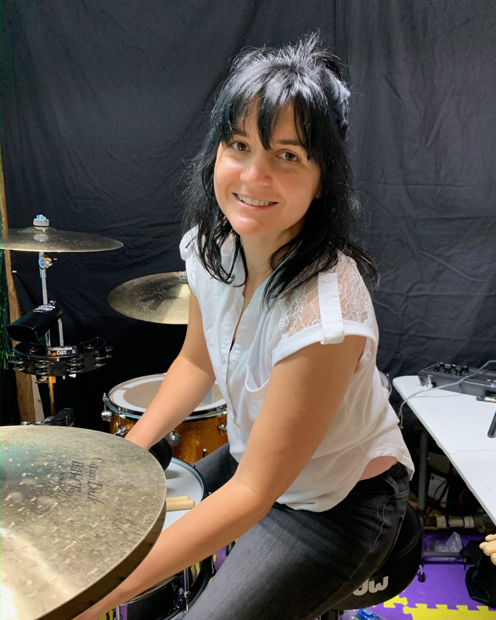 Brittany at her kit in a white lace top